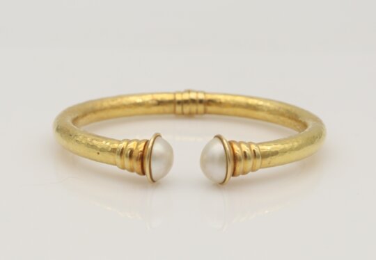 149: An 18K Gold and Cultured Pearl Hammered Open Bangle